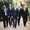 group of men walking together in suits confident